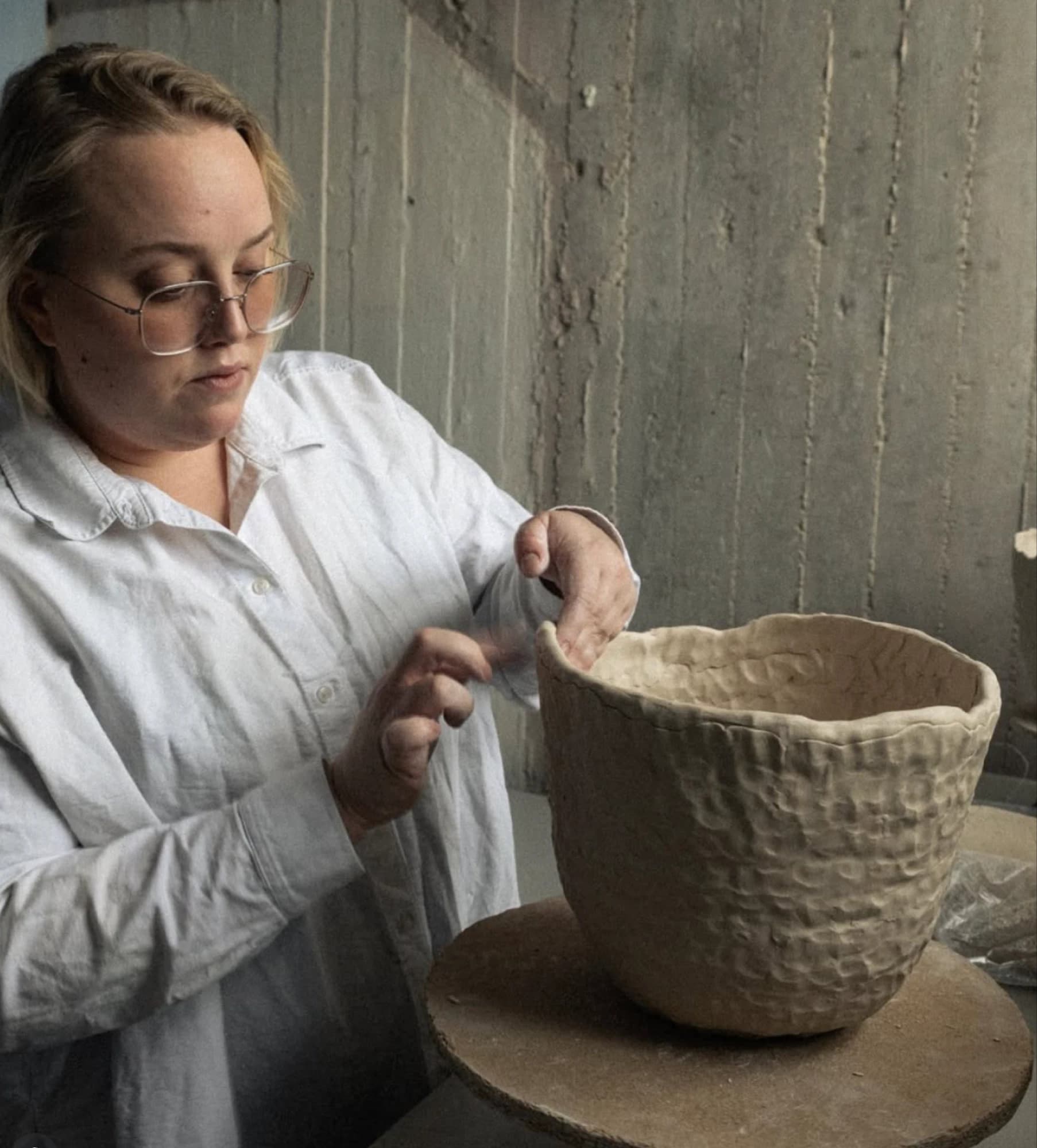 Sofi Gunnstedt shaping a ceramic vase in her studio